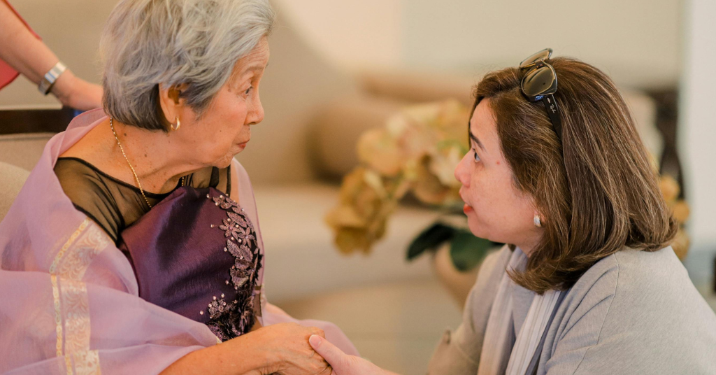 Daughter talking with elderly mother about changes at home and need for support