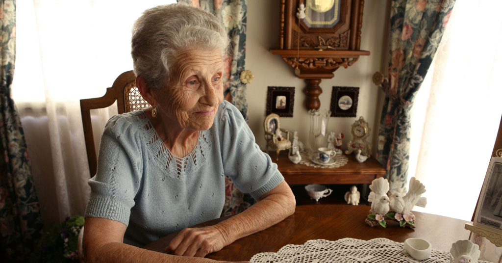 aging parent sharing family keepsakes during downsizing
